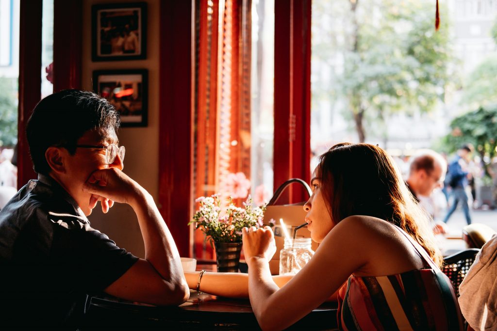 Introverted man over 40 talking with a woman at a social event